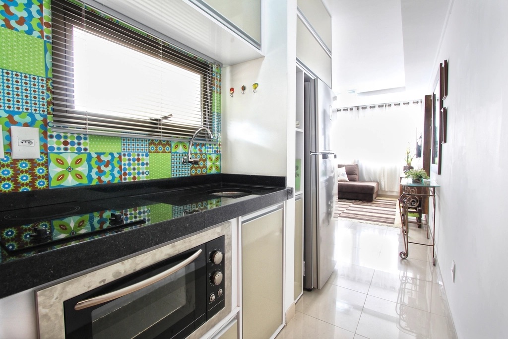 A compact kitchen with patterned tiles